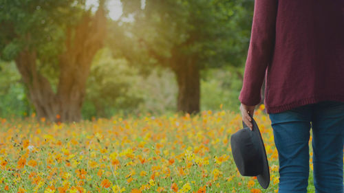 Rear view of person standing on field