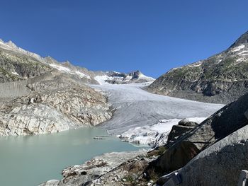 Scenic view of snowcapped mountains against clear blue sky