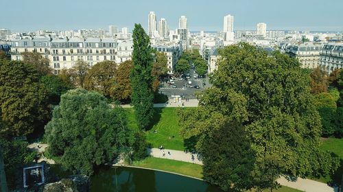 Panoramic view of trees and cityscape against sky