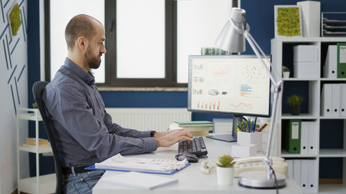 Side view of businessman working at office