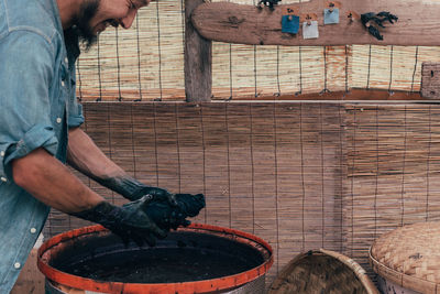 Side view of man working on wood