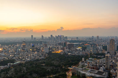 High angle view of buildings in city during sunset