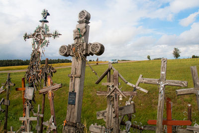 Wooden fence on field against sky