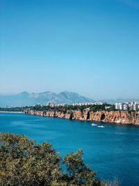 Scenic view of sea against clear blue sky