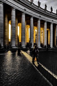 People walking in front of historical building