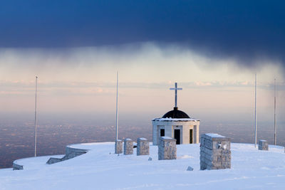 Church and buildings against sky during winter