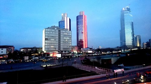 Illuminated cityscape against clear sky