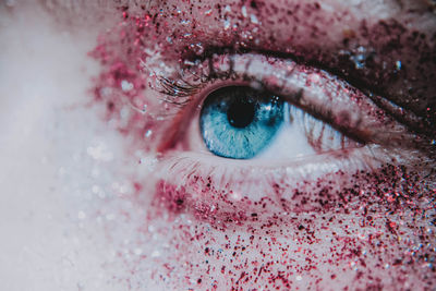 Close-up of human eye covered with glitter