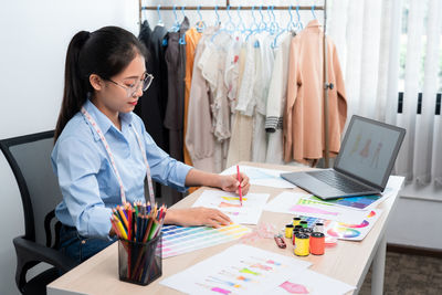 Portrait of young businesswoman working at desk in office