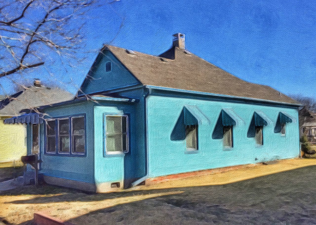 CLOSE-UP OF BUILT STRUCTURES AGAINST BLUE SKY