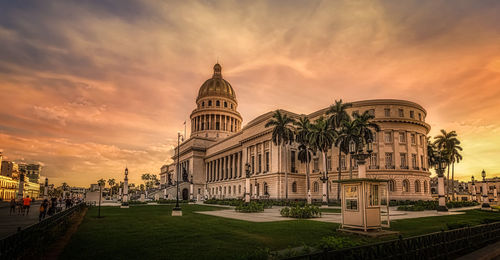 Building against sky during sunset in city