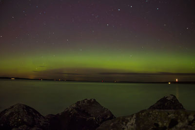 Scenic view of lake against sky at night