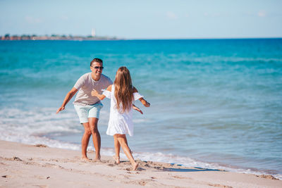 Full length of woman on beach against sky