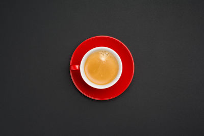 Directly above shot of coffee cup against black background