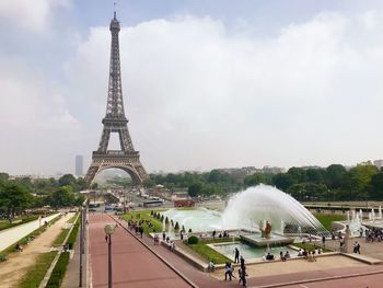 Fountain in city against sky