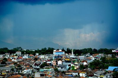 Houses in town against sky