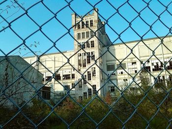 Close-up of chainlink fence against sky