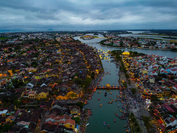 High angle view of townscape by sea against sky