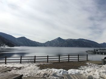 Scenic view of lake and mountains against sky