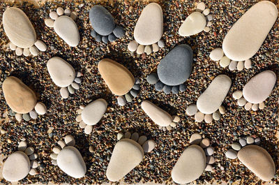 Full frame shot of pebbles in foot shape at beach