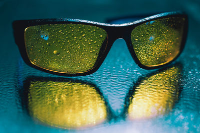 Close-up of sunglasses against blue sky