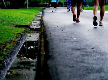 Low section of people walking on road