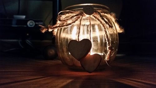 Close-up of illuminated lamp on table