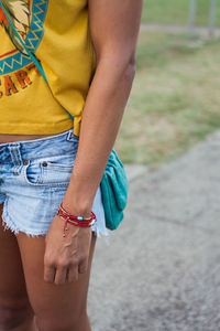 Midsection of woman standing outdoors