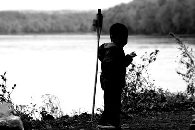 Rear view of boy standing on field