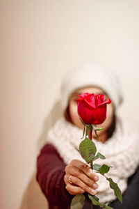 Midsection of woman holding rose
