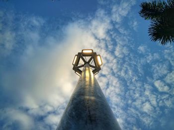 Low angle view of tree and building against sky