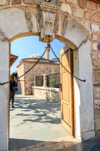 Rear view of man walking outside building