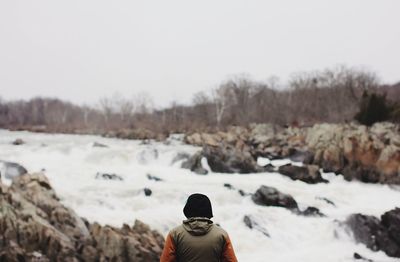 Person standing on snow covered landscape