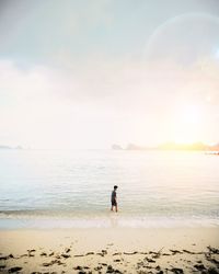 Man standing in sea against sky