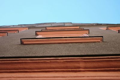 Roof of building against clear blue sky