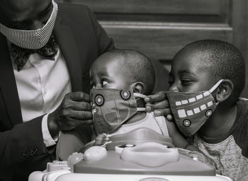 Portrait of father and sons wearing face masks