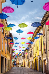 Multi colored umbrellas against sky