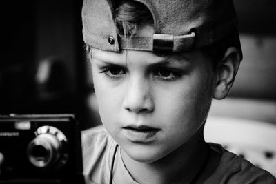 Close-up portrait of boy photographing