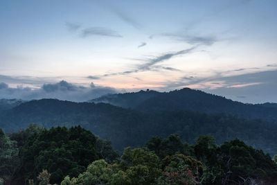 Scenic view of mountains against sky at sunset