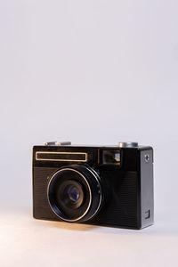 Close-up of camera against white background