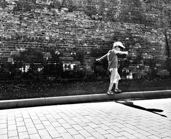 Full length of woman standing by railing