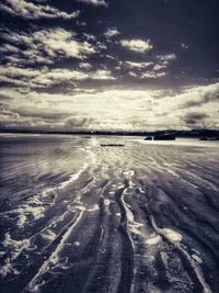 Scenic view of beach against sky during sunset