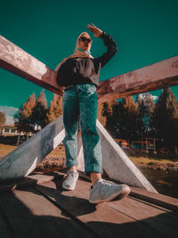 Full length of man wearing sunglasses standing against sky