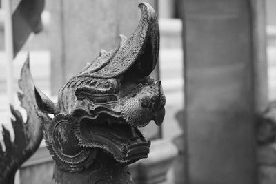 Close-up of animal statue against old building