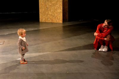 Side view of a boy walking on floor