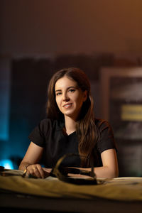 Young woman sitting on table