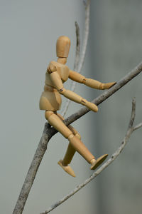 Low angle view of figurine on wood against tree