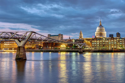 St. paul's cathedral and the millennium bridge in london, uk, after sunset