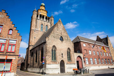 Low angle view of historic building against blue sky