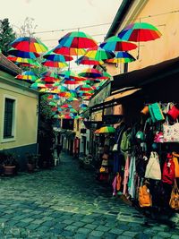 Multi colored umbrellas hanging at market stall